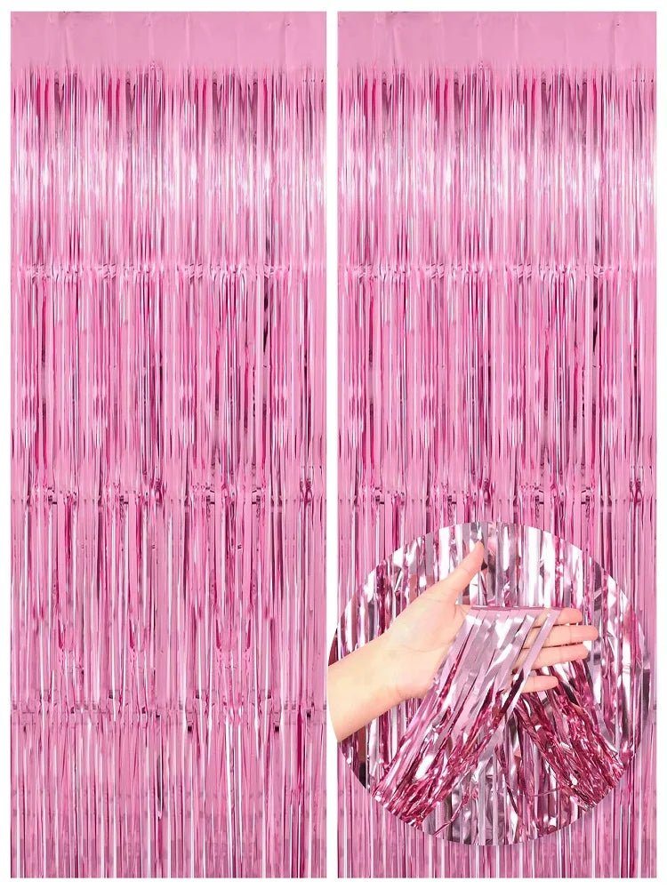Two panels of metallic pink foil fringe curtains hanging vertically.