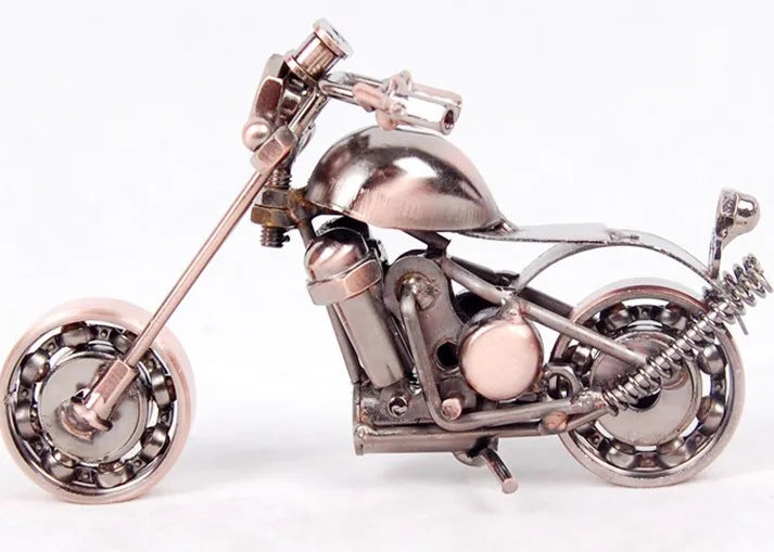 A handcrafted metal motorcycle model with a silver finish displayed against a white background.