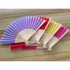 A fan of multiple colors, including purple, pink, red, and yellow, made with a bamboo frame.