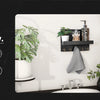 A rustic wooden wall-mounted organizer displaying jewelry, coats, hats, phones, and ties in a home laundry setting.