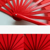 A close-up view of a red bamboo folding fan with multiple slats, showing the mechanism and color.