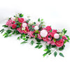 A lush arrangement of pink and white artificial roses and greenery for event decor.