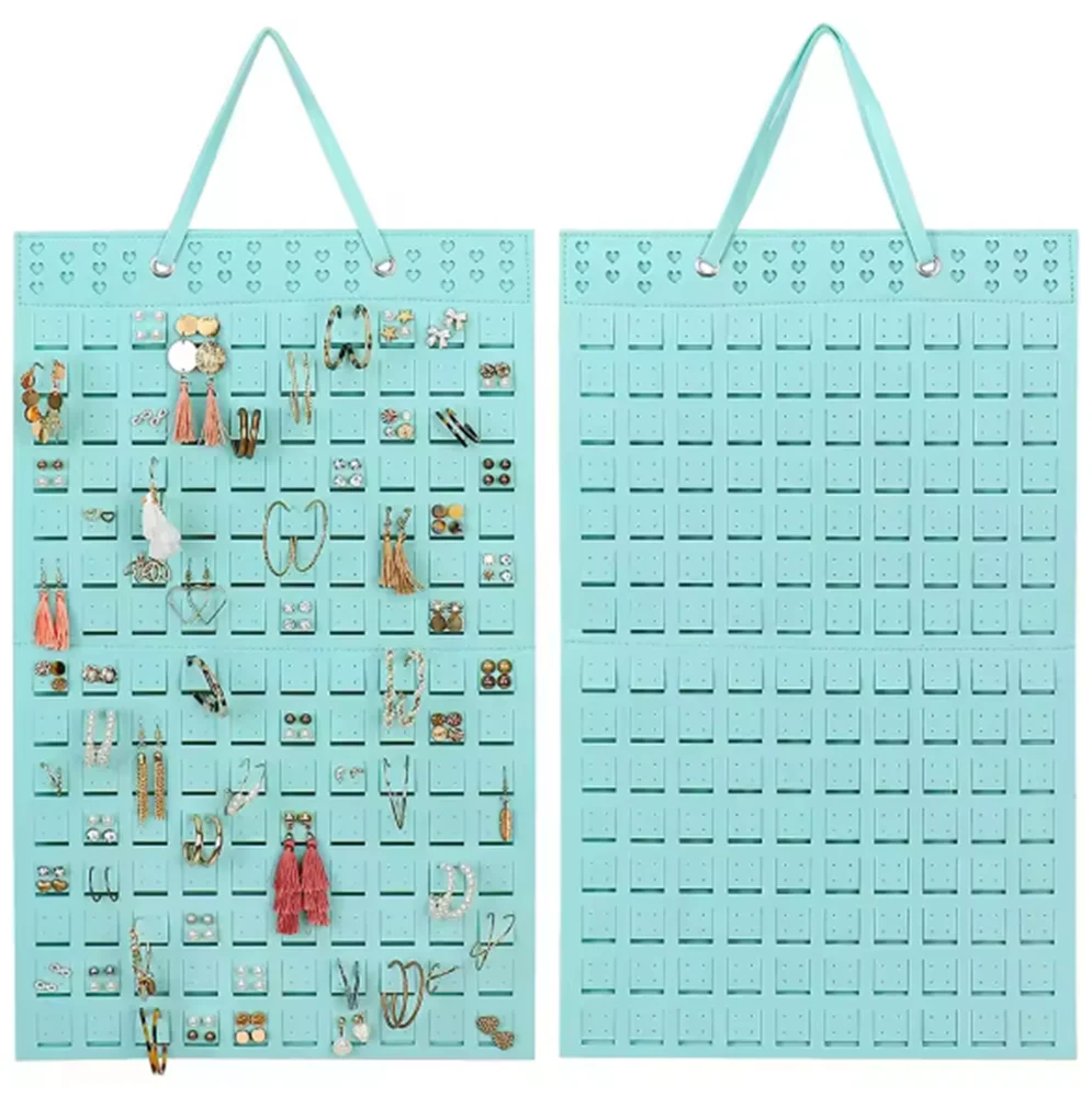 A light blue felt organizer display for wall mounting, featuring numerous small earrings and jewelry pieces.