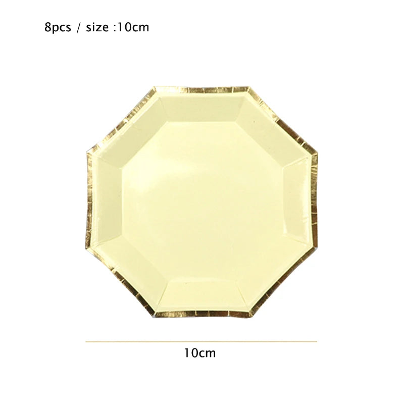 A gold disposable party tableware set featuring a yellow hexagonal plate with a gold rim.