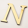 A gold acrylic mirror letter N wall sticker for self-adhesive decor.