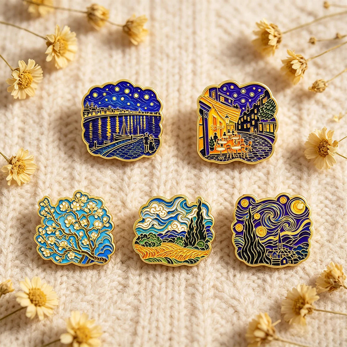 A set of five enamel pins featuring Van Gogh's art, including Starry Night and other classic paintings, displayed on a beige 