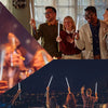 A group of people celebrating with fiber optic LED glow wands in a festive indoor setting.