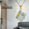 A gold chain necklace featuring an openable book pendant engraved with the message Mi Campeón
