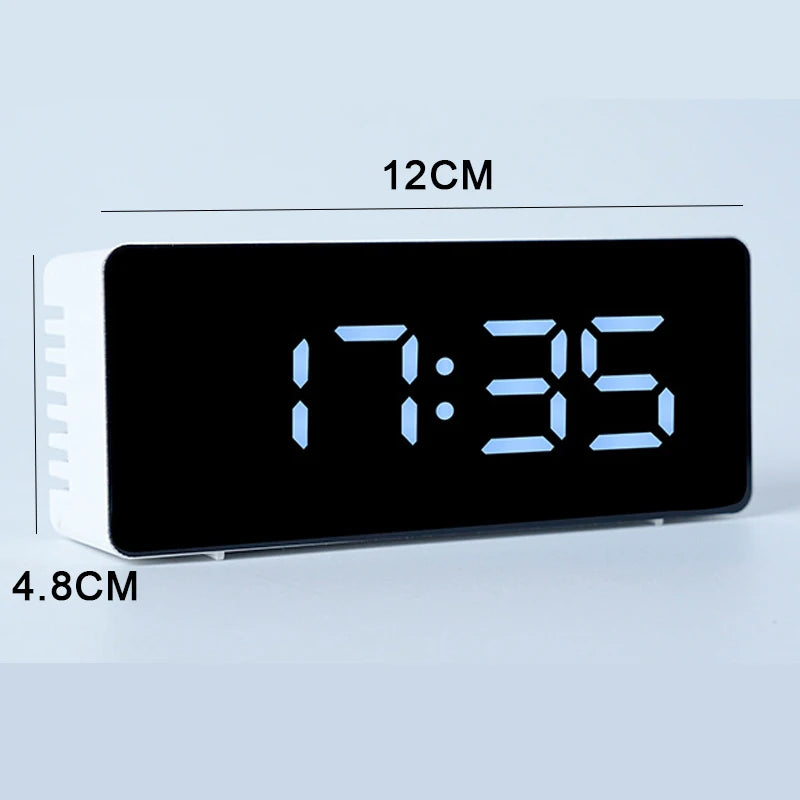 A black LED digital alarm clock displaying 7:35, with dimensions of 12cm by 4.8cm.