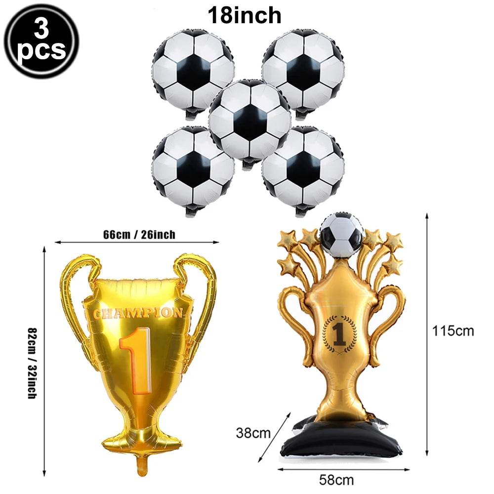 A set of three silver soccer balls and a gold championship trophy for party decoration.