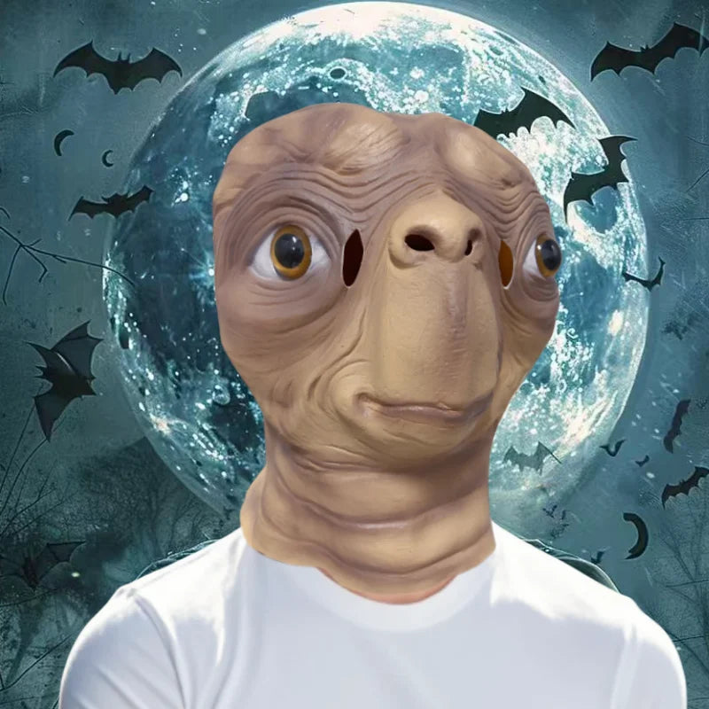 A realistic cute alien full-face latex mask with large eyes and skin texture against a moonlit background.