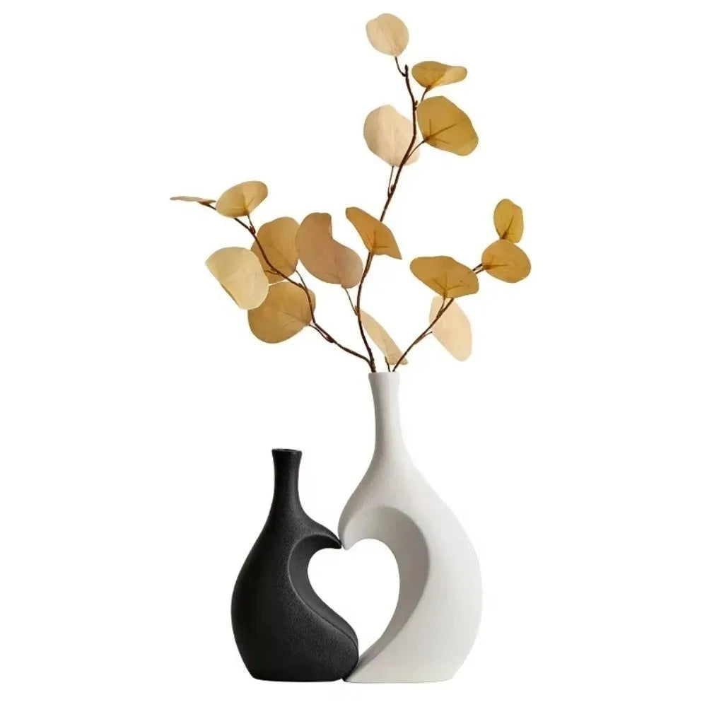 Modern heart-shaped ceramic vase with delicate dried leaves