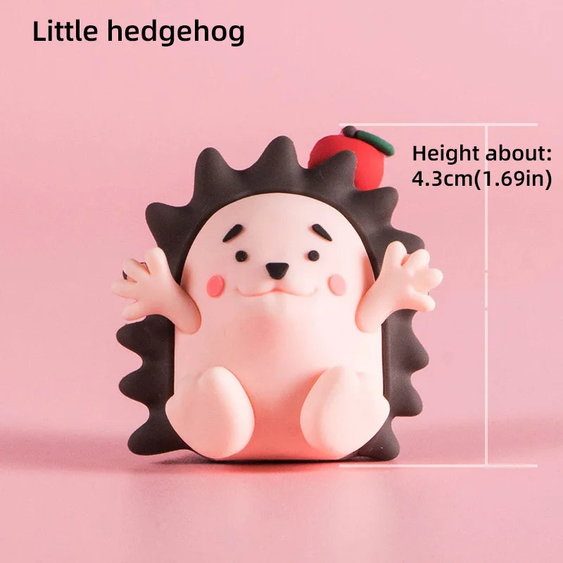 A small, pink hedgehog-shaped cake topper with black spines and a cute face.