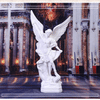 A white resin figurine of Saint Michael Archangel with large wings standing in a grand architectural setting.