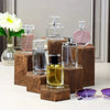 A collection of glass perfume bottles displayed on a wooden hexagonal rack.