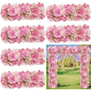 A close-up display of artificial silk pink and magenta rose flower panels used for weddings and events.