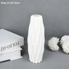 A tall, white, Nordic style decorative plastic vase is shown against a gray background.