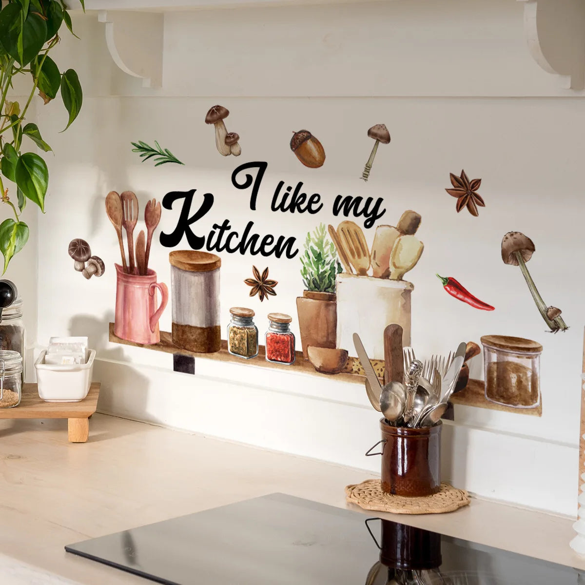 A white wall decorated with illustrations of mushrooms and kitchen utensils, featuring the text I like my kitchen.