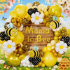 A yellow and gold balloon garland featuring bees and flowers for a Mama to Bee celebration.