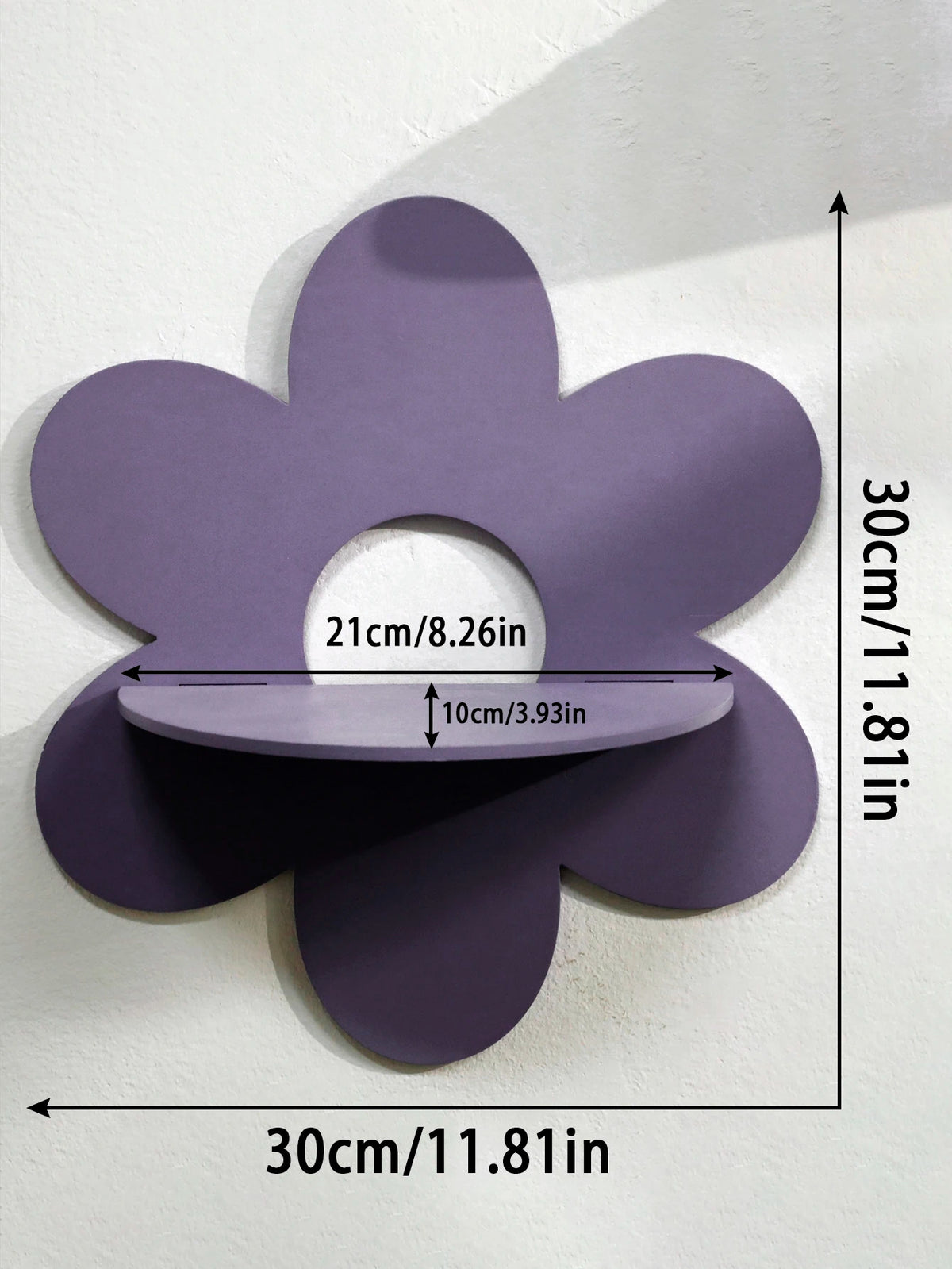 A purple cherry-shaped wooden wall shelf with a cutout for display, mounted on a white wall.