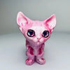 A pink articulated 3D printed figurine of a Siamese cat with large blue eyes.