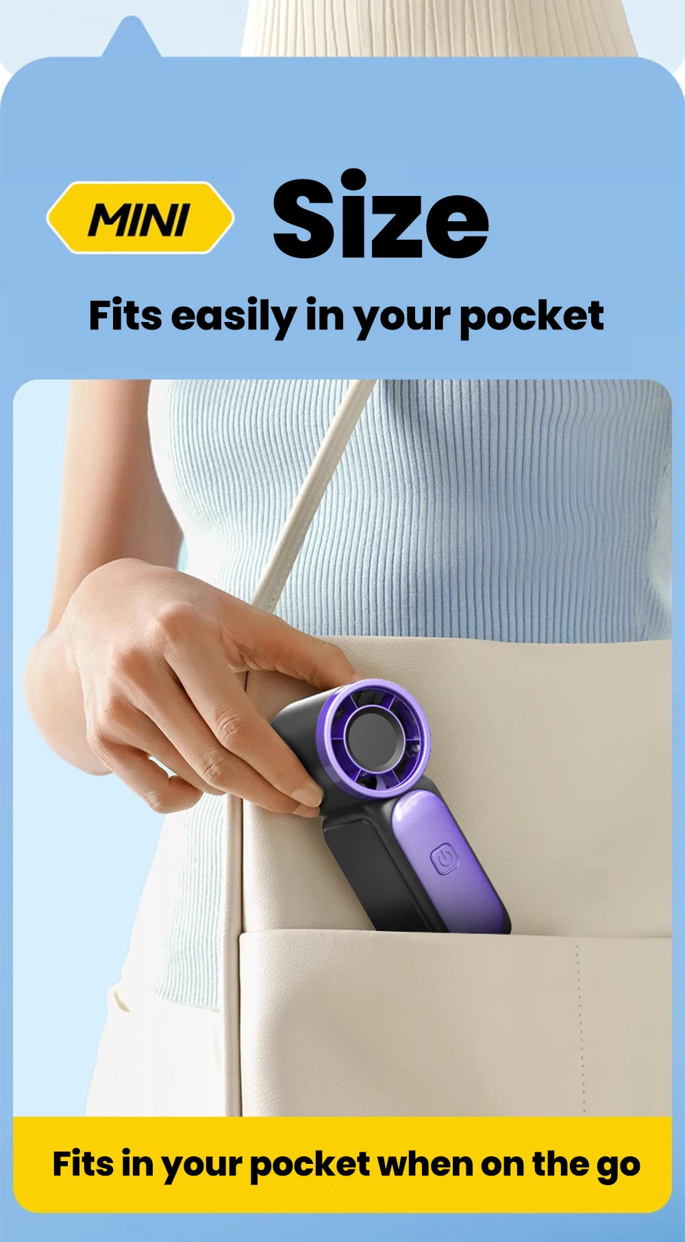 A hand places a purple and black portable handheld fan into a pocket of a light-colored bag.