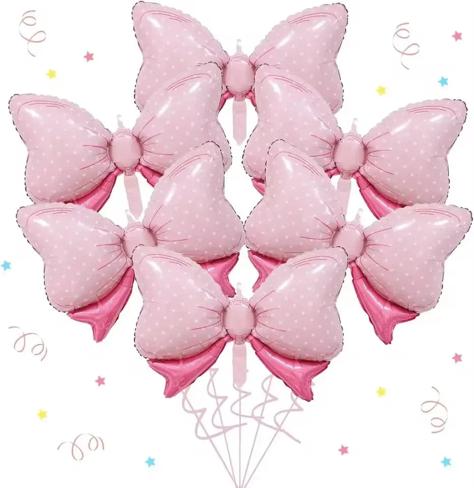 A pack of six pink, polka-dotted bow balloons used for party decorations.