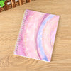A colorful reusable sticker collecting album with a watercolor gradient design on a wooden surface.