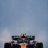 A Formula 1 racing car is photographed against a gray sky.
