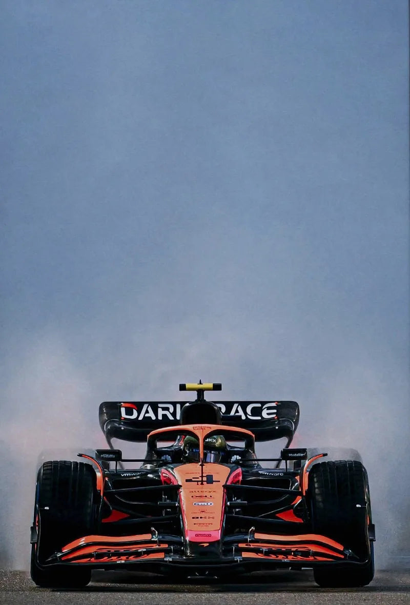A Formula 1 racing car is photographed against a gray sky.