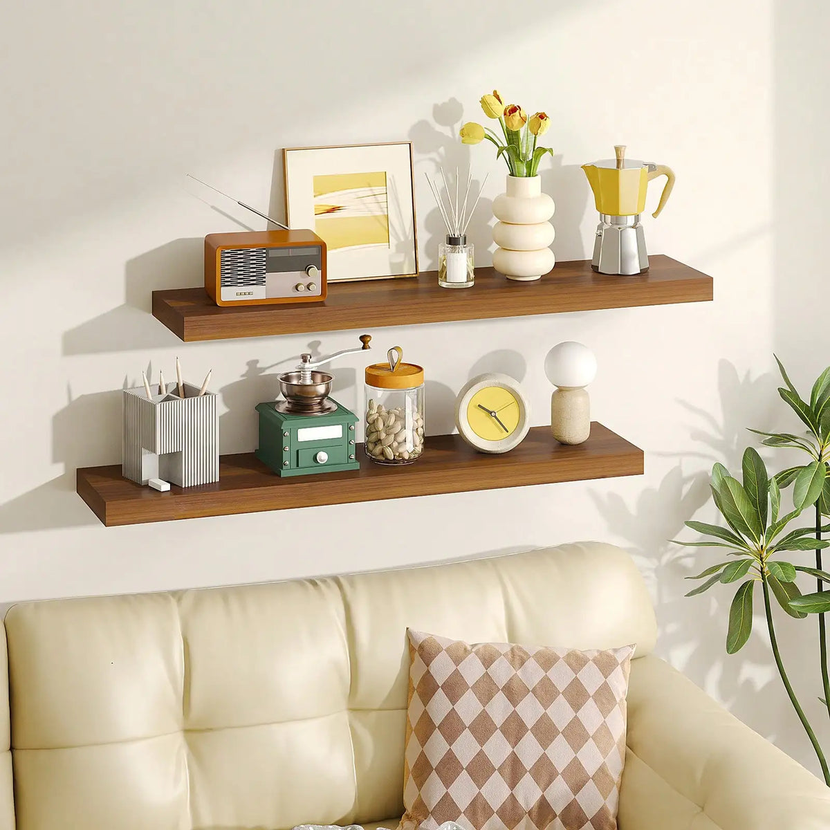A set of two wooden floating wall shelves displaying yellow and white kitchenware and decorative items.