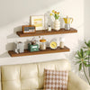 A set of two wooden floating shelves displaying various kitchen and decorative items on a light-colored wall.