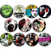 A set of collectible button pins featuring various designs and artwork related to the band Green Day.