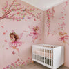 A pink nursery wall decorated with butterfly and fairy decals, featuring a white crib.