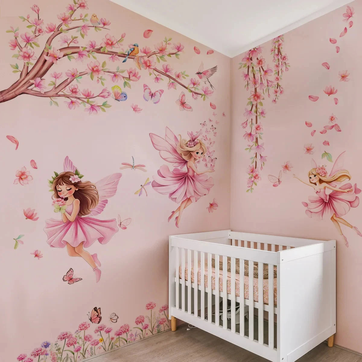 A pink nursery wall decorated with butterfly and fairy decals, featuring a white crib.