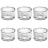 A set of nine clear glass tealight candle holders with decorative fluted patterns.
