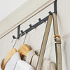 A wooden and metal 5-hook iron door and wall organizer rack mounted on a white surface.