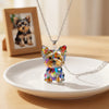 A colorful acrylic pendant necklace featuring a Yorkshire Terrier charm displayed on a white plate.