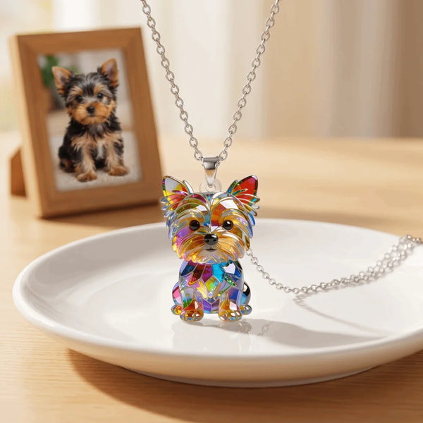 A colorful acrylic pendant necklace featuring a Yorkshire Terrier charm displayed on a white plate.