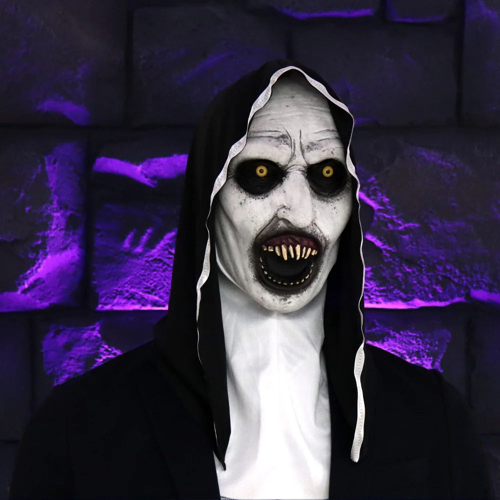 A realistic horror nun latex mask with pale skin, exaggerated features, and dark clothing against a purple background.