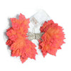A set of bright orange and red faux autumn leaves attached to a clear LED string light wire.
