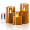 A set of three amber glass LED flameless candles with flickering flame effects displayed on a white surface.