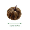 A small, fuzzy brown foam pumpkin with a stem, shown against a white background.