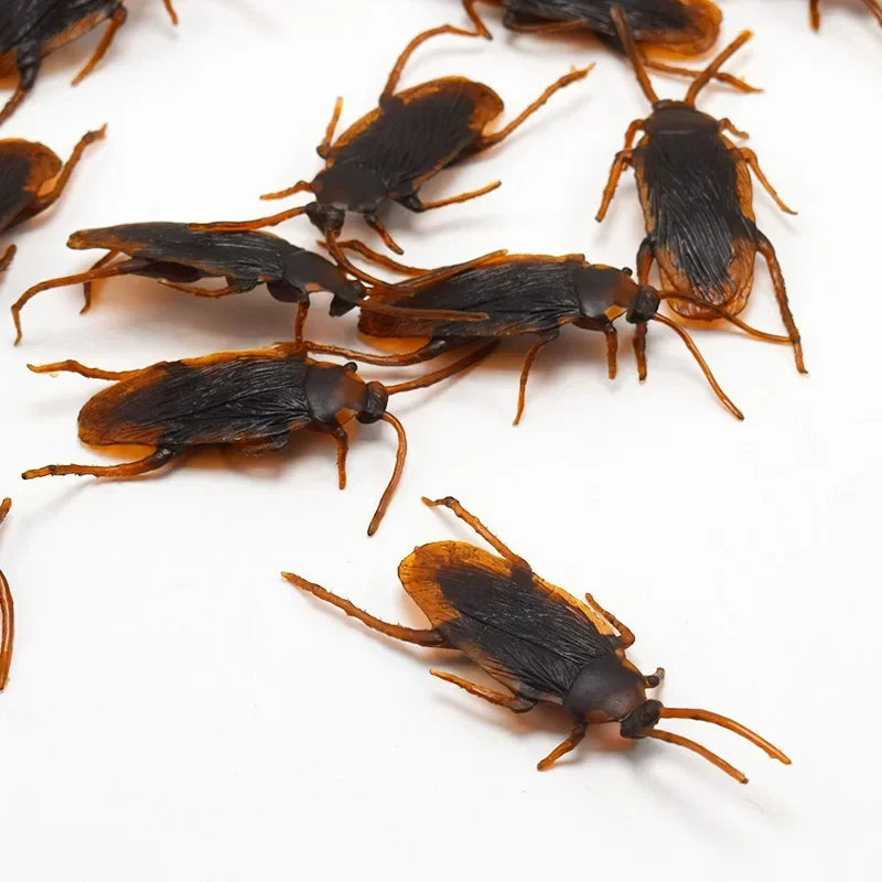 A collection of realistic plastic bugs including cockroaches, centipedes, and scorpions.