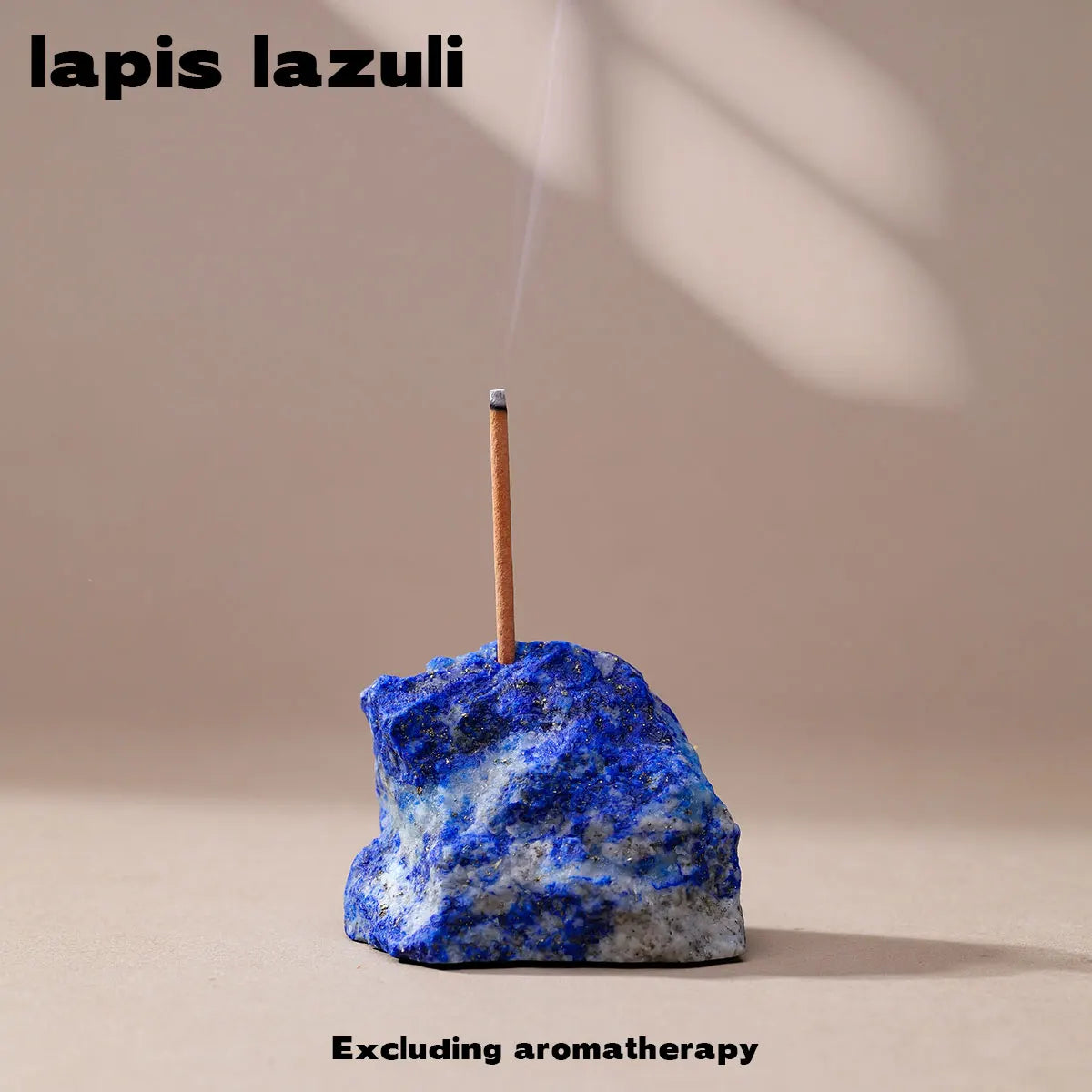 A piece of lapis lazuli stone with a wooden stick and a small flame, used as an aromatherapy holder.