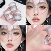 Close-up of a woman applying Fairy Body Glitter Highlight Powder to her face and hand.