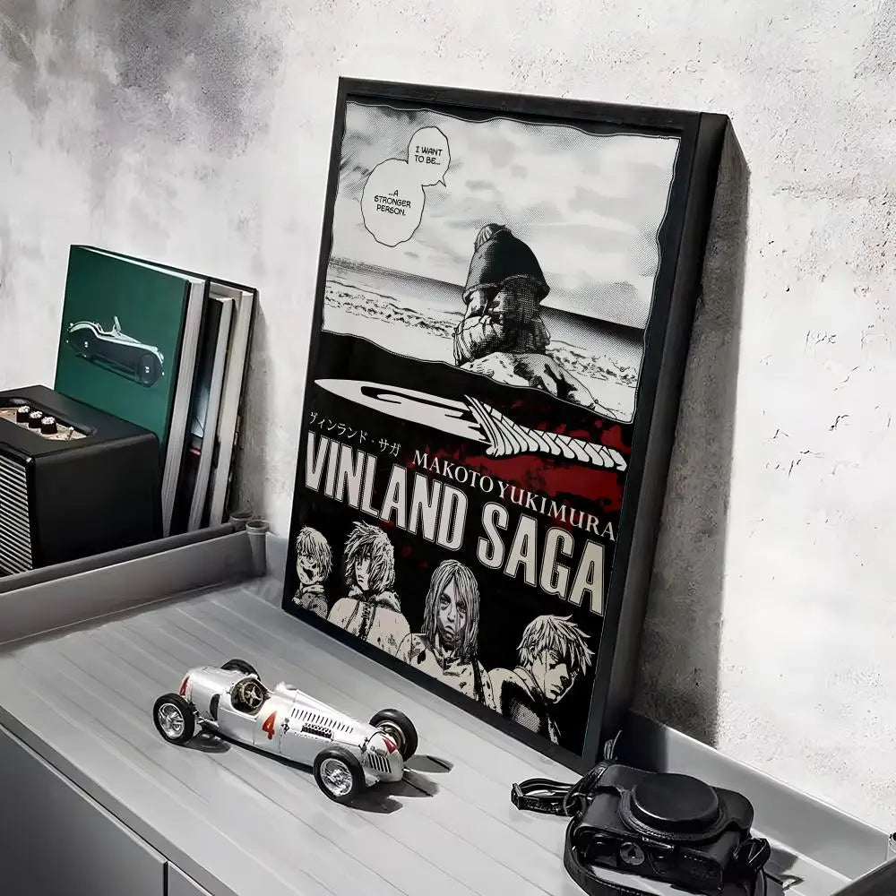 A framed poster of the Vinland Saga anime featuring a warrior figure against a snowy landscape.