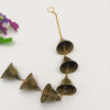 A brass wind chime with multiple bronze bells hanging from a gold chain.