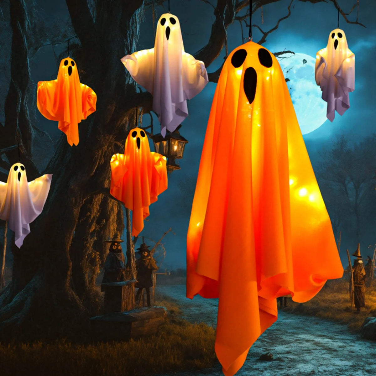 Orange glowing ghost decorations hanging from a tree in a dark outdoor setting.
