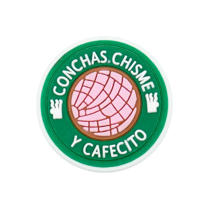 Green circular charm with pink texture and text in Spanish: CONCHAS CHISME Y CAFECITO